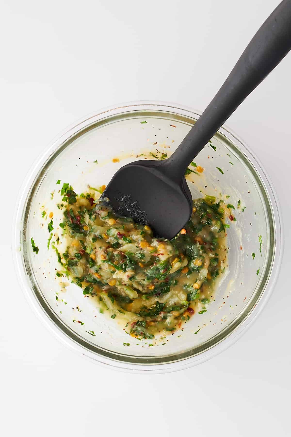 Cheesy garlic bread seasonings being combined in a bowl.
