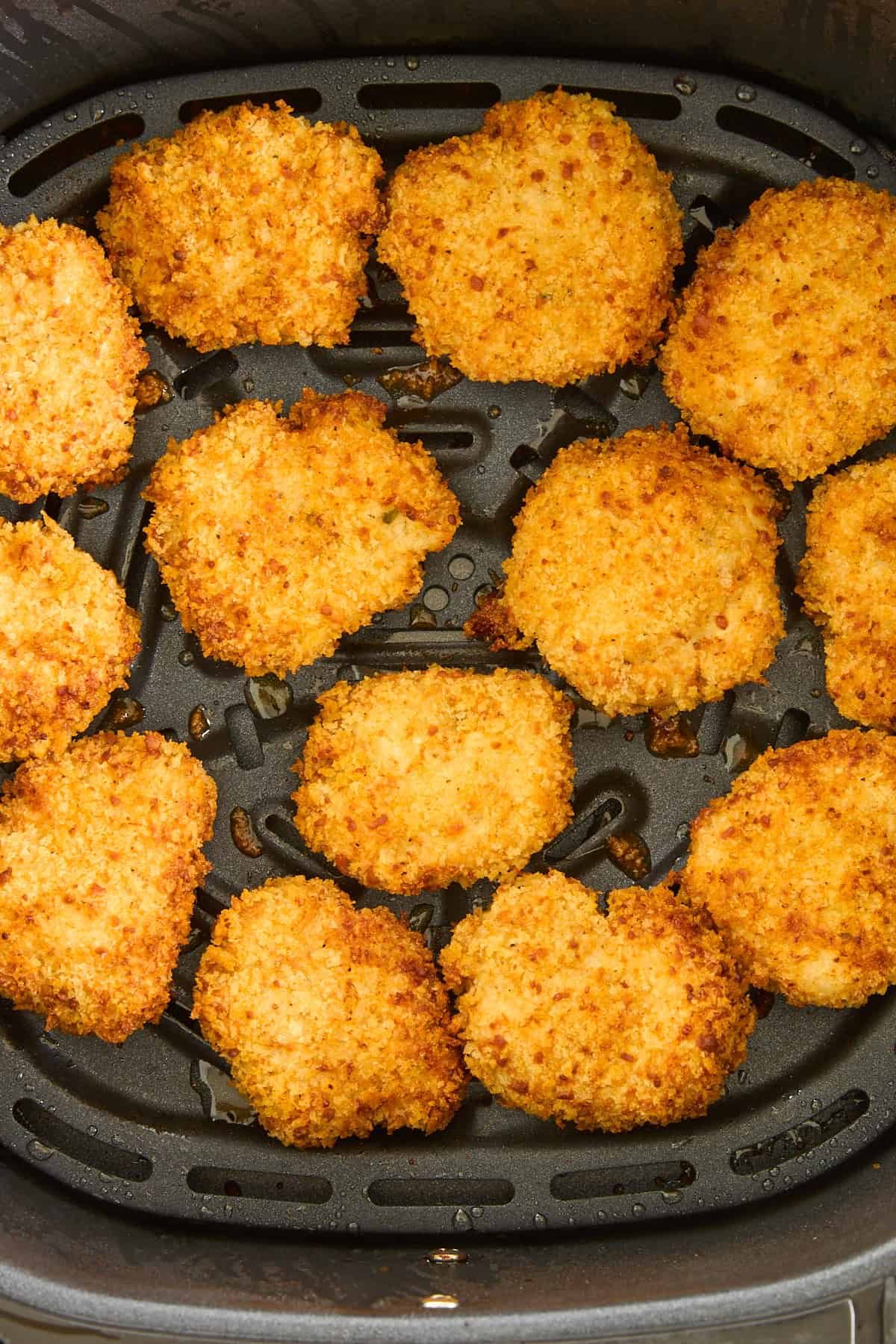 Cooked chicken nuggets in an air fryer.