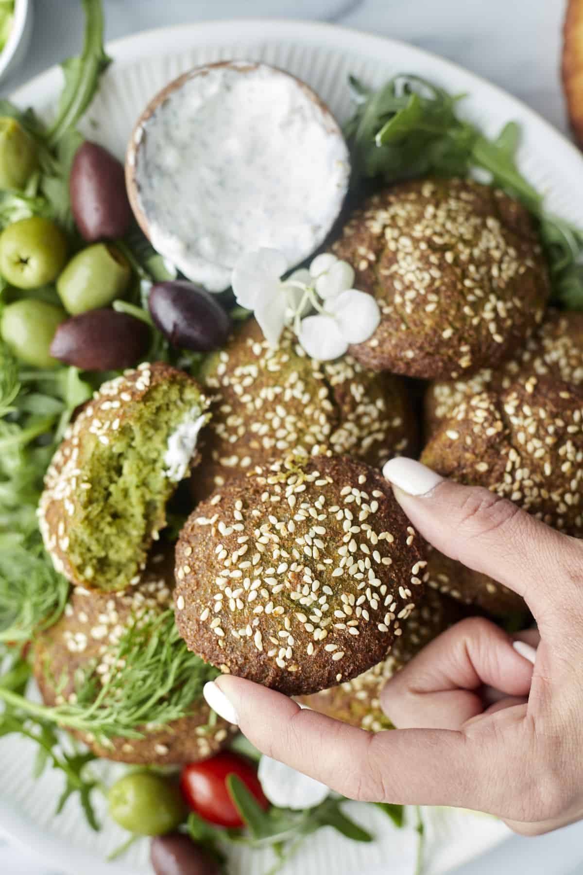 a hand holding an air fryer falafel.