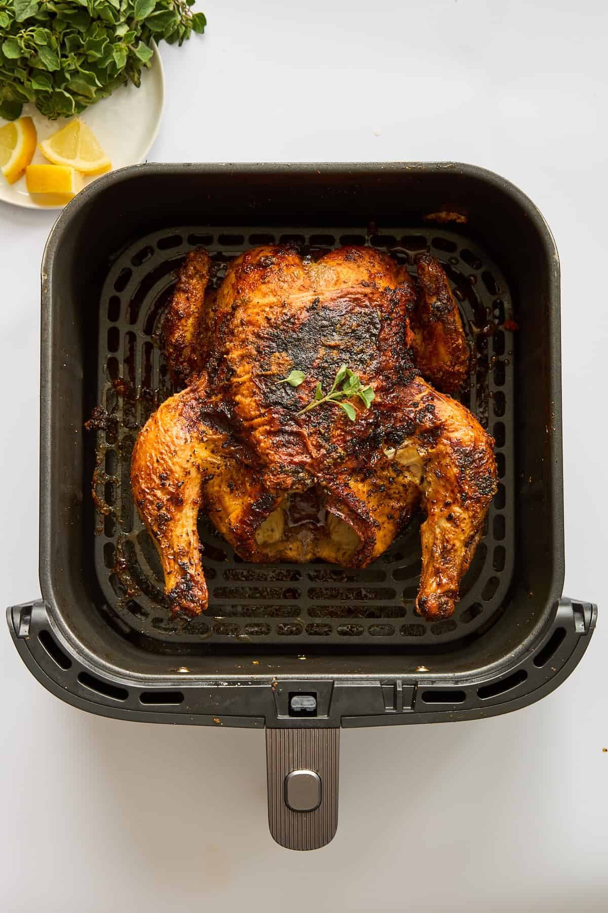 A whole cooked chicken in the air fryer.