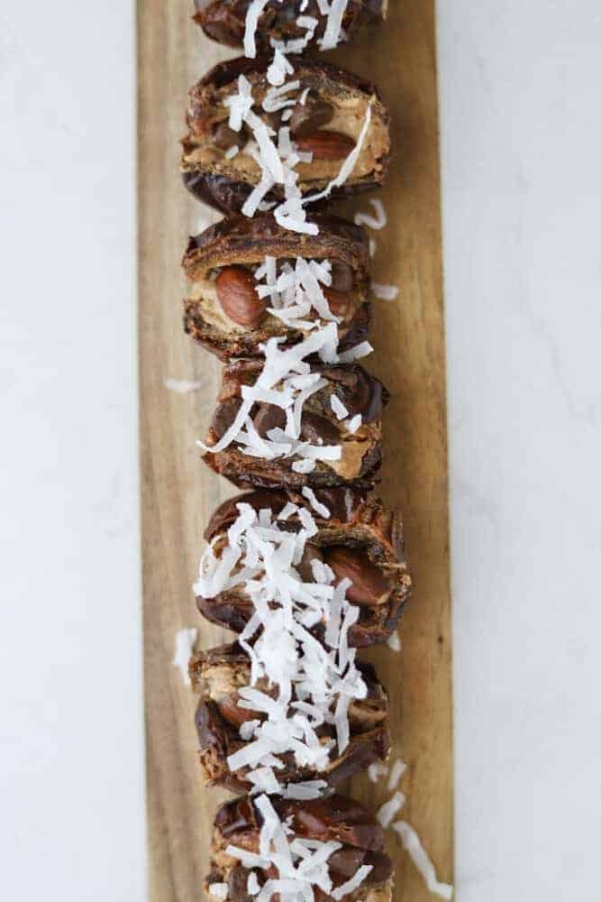 almond joy dates stuffed with nut butter, almond, chocolate chips, and coconut flakes