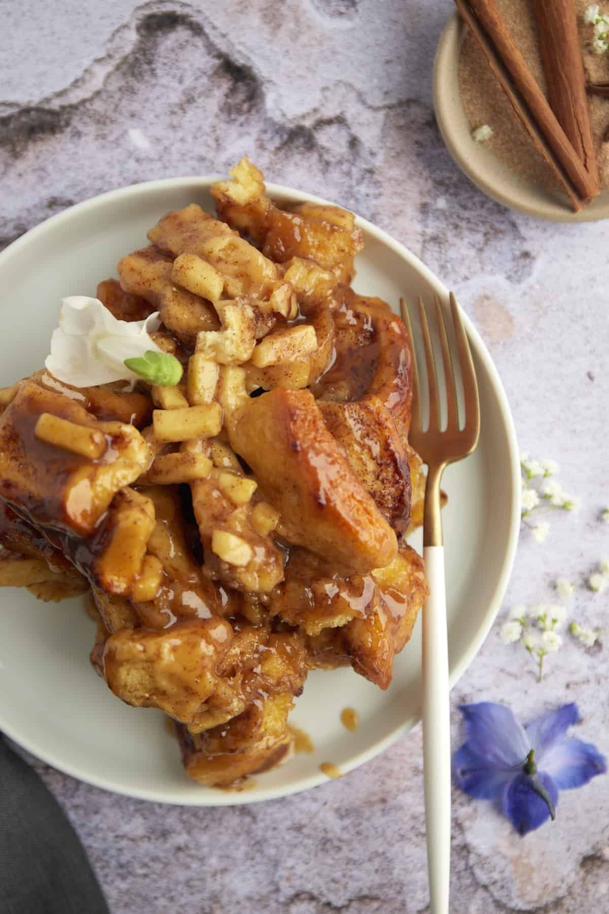 a plate with apple caramel cinnamon rolls
