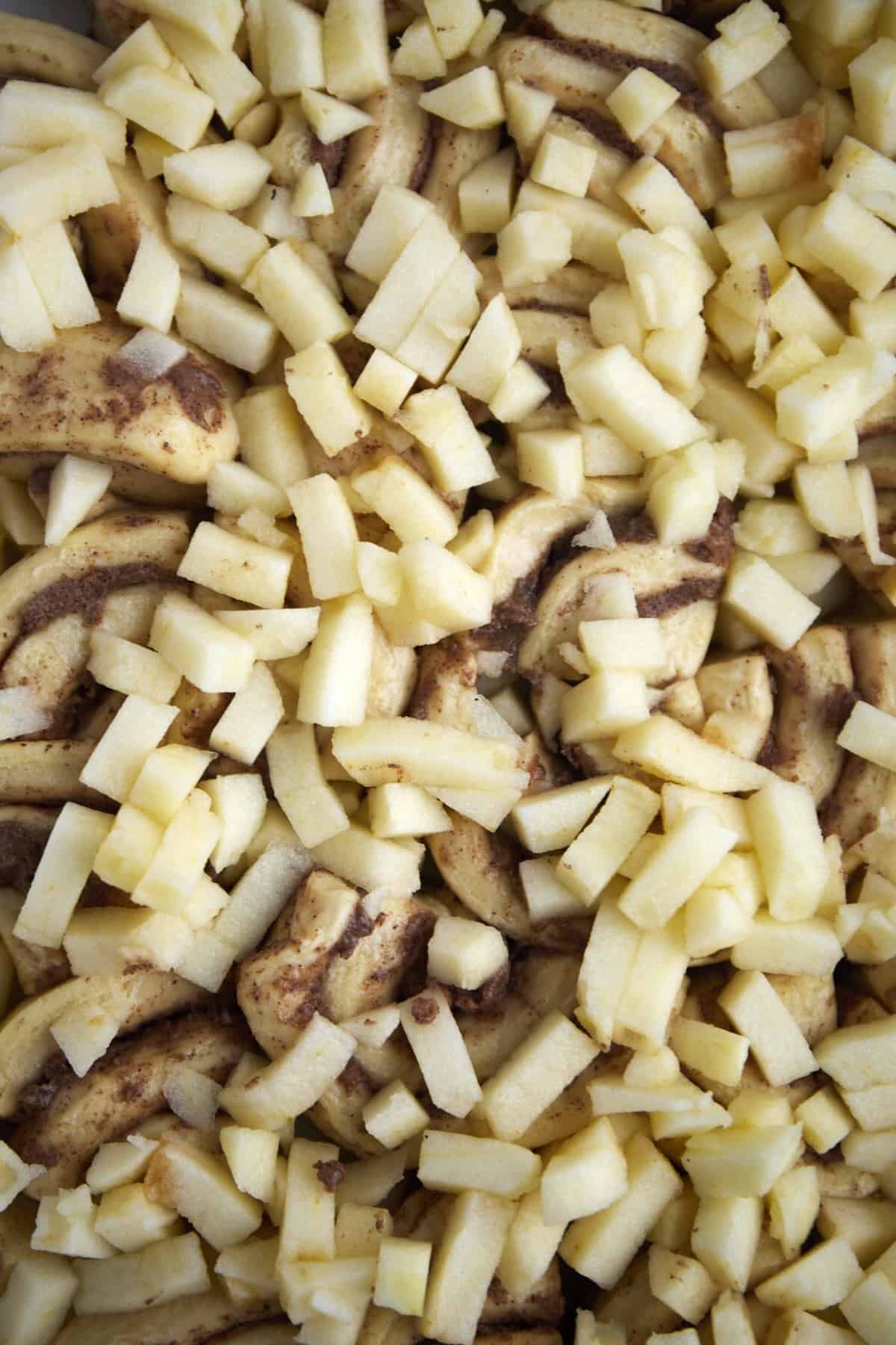 cinnamon roll dough topped with chopped apple pieces