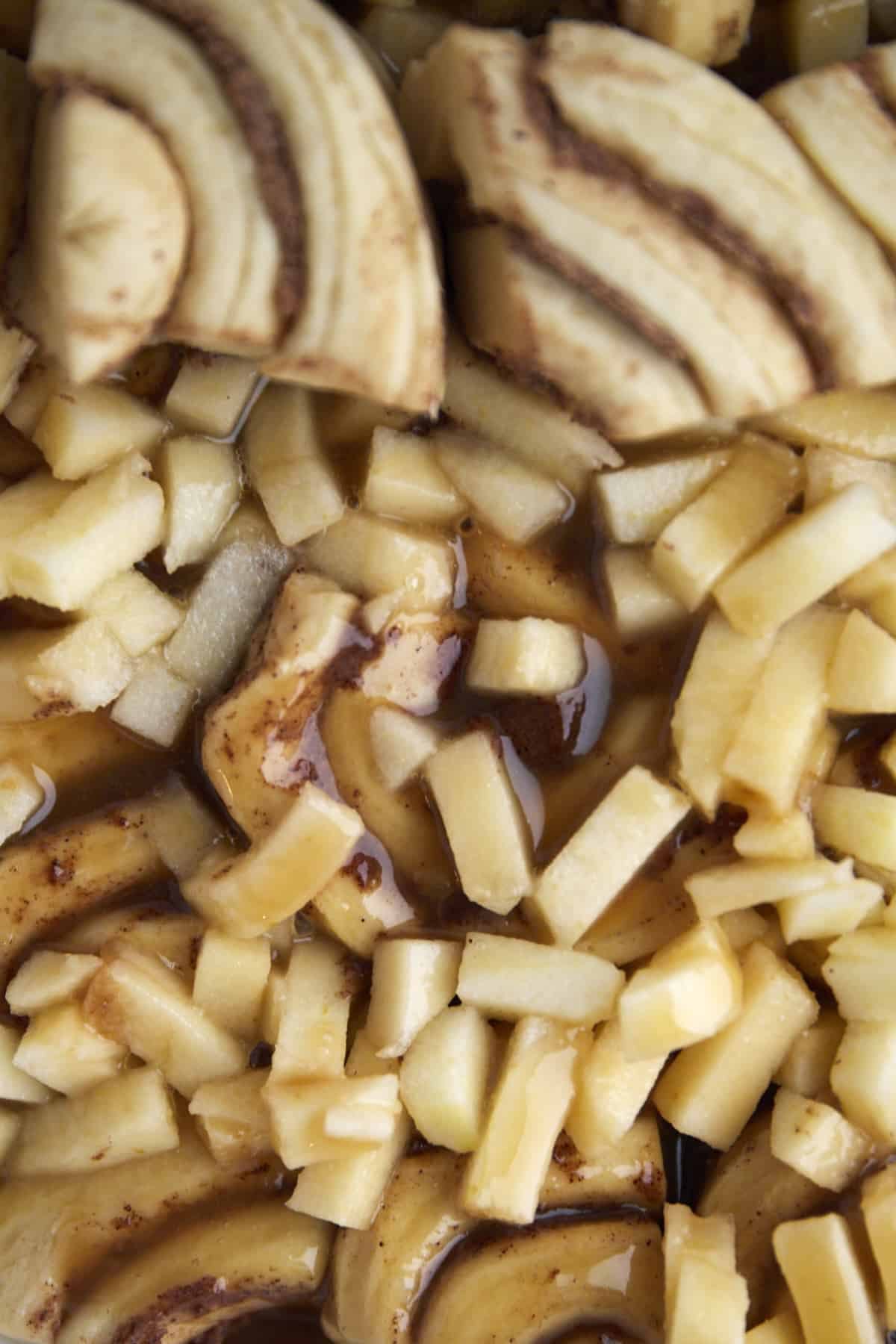quartered dough topped with apple chunks and caramel