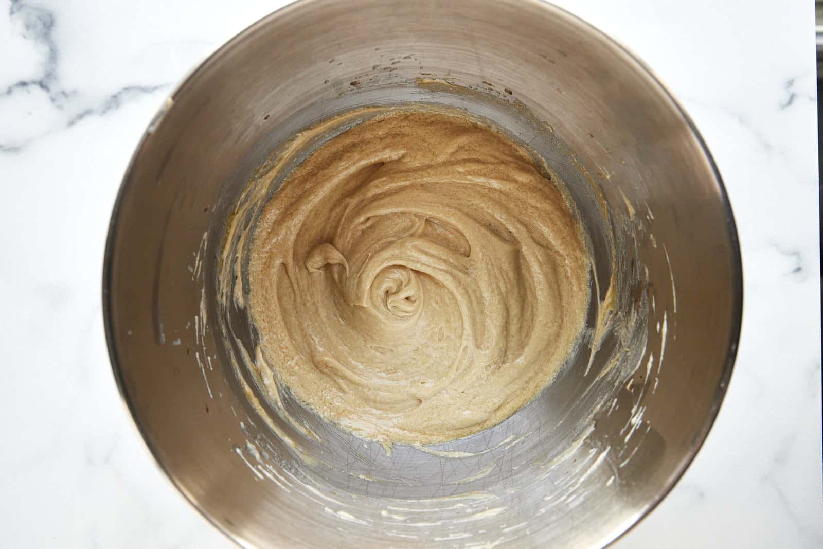 Combined wet ingredients for apple cider donuts in a bowl.