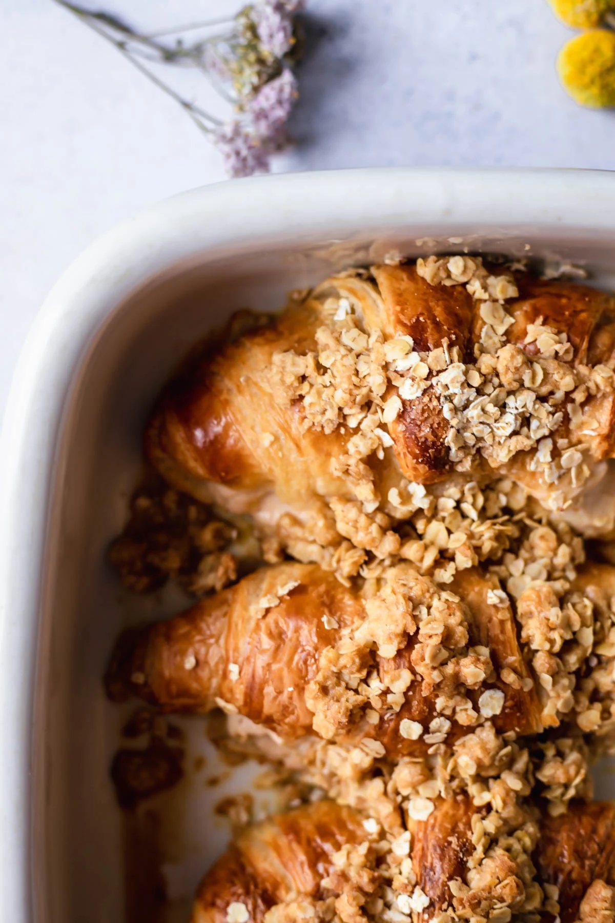 baking dish full of cinnamon crisp apple french toast bake croissants