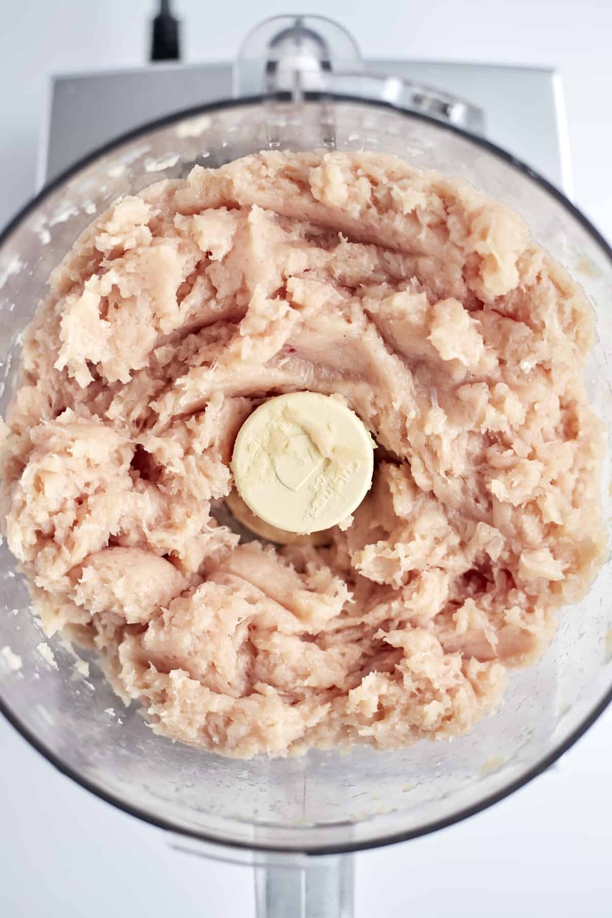 pieces of chicken in a food processor.