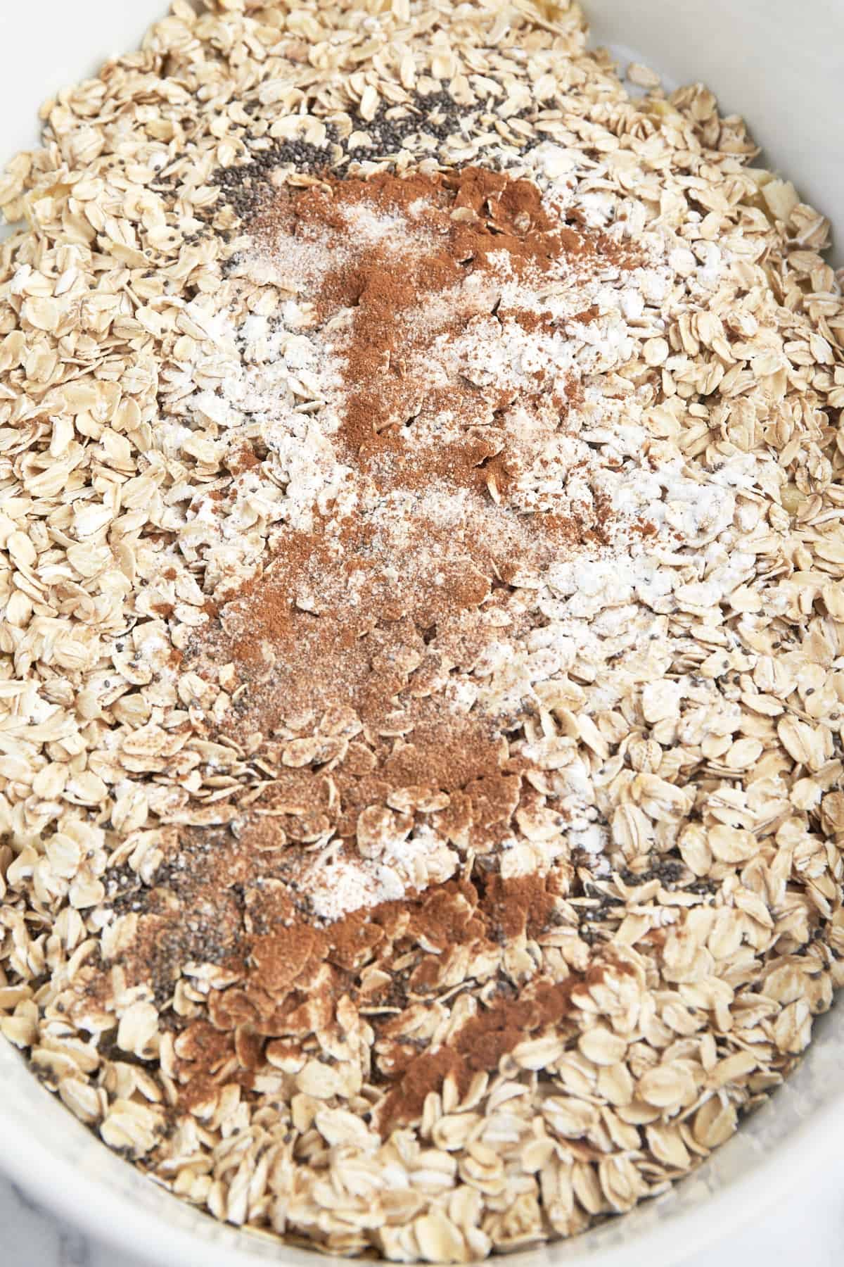 Dry ingredients for baked apple oatmeal in a baking dish.