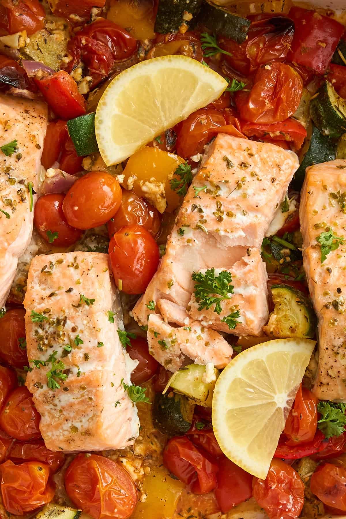 Close up image of baked feta salmon with tomatoes.
