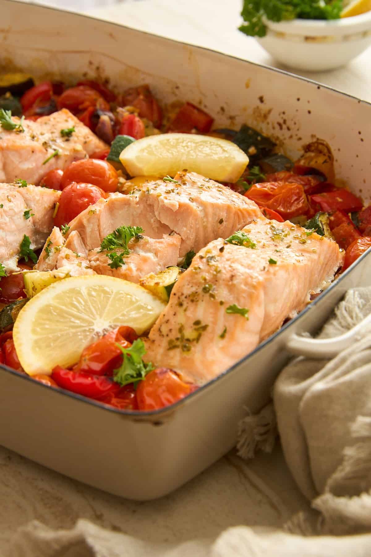 A baking dish of feta salmon with cherry tomatoes.