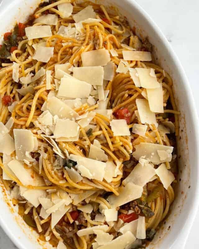 Baked spaghetti bolognese topped with shaved parmesan