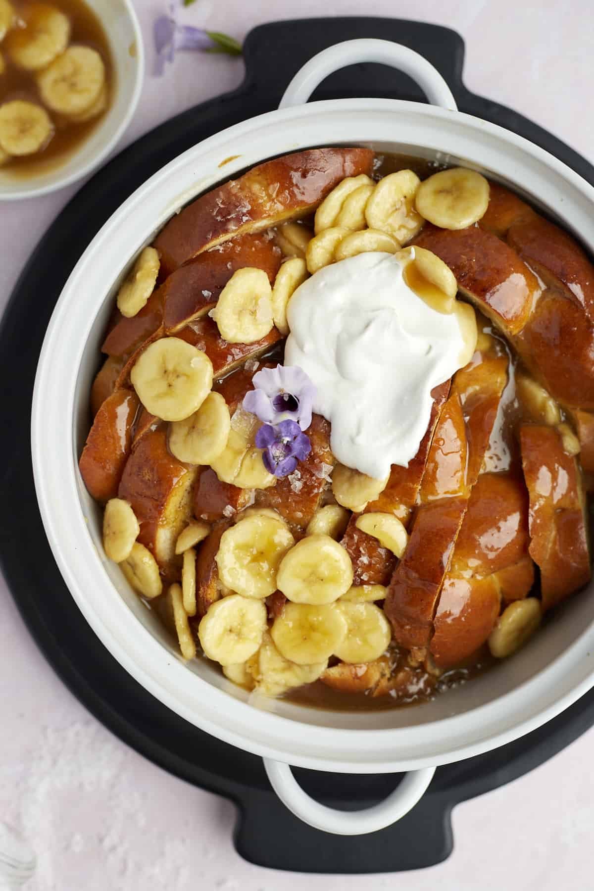 baked bananas foster french toast topped with banana slices and creme fraiche
