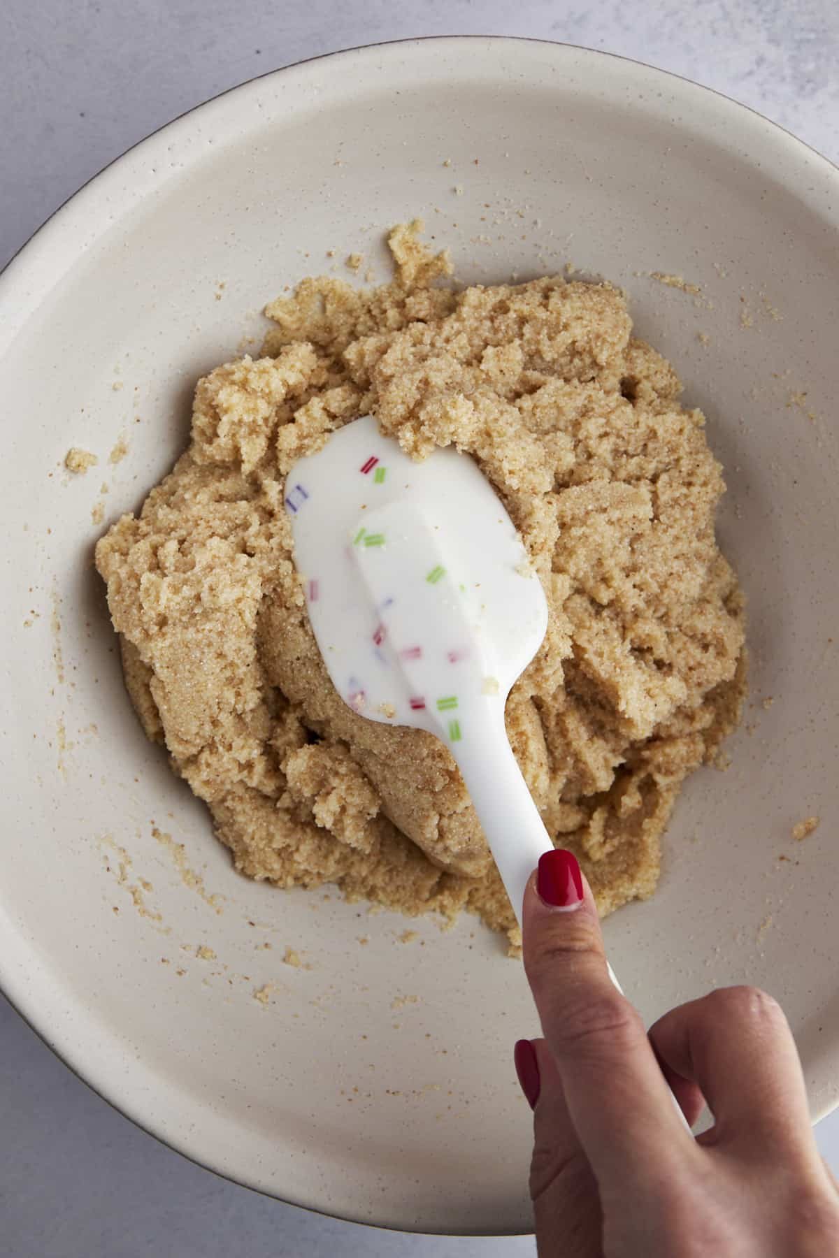 Dry ingredients for basbousa batter being stirred together.