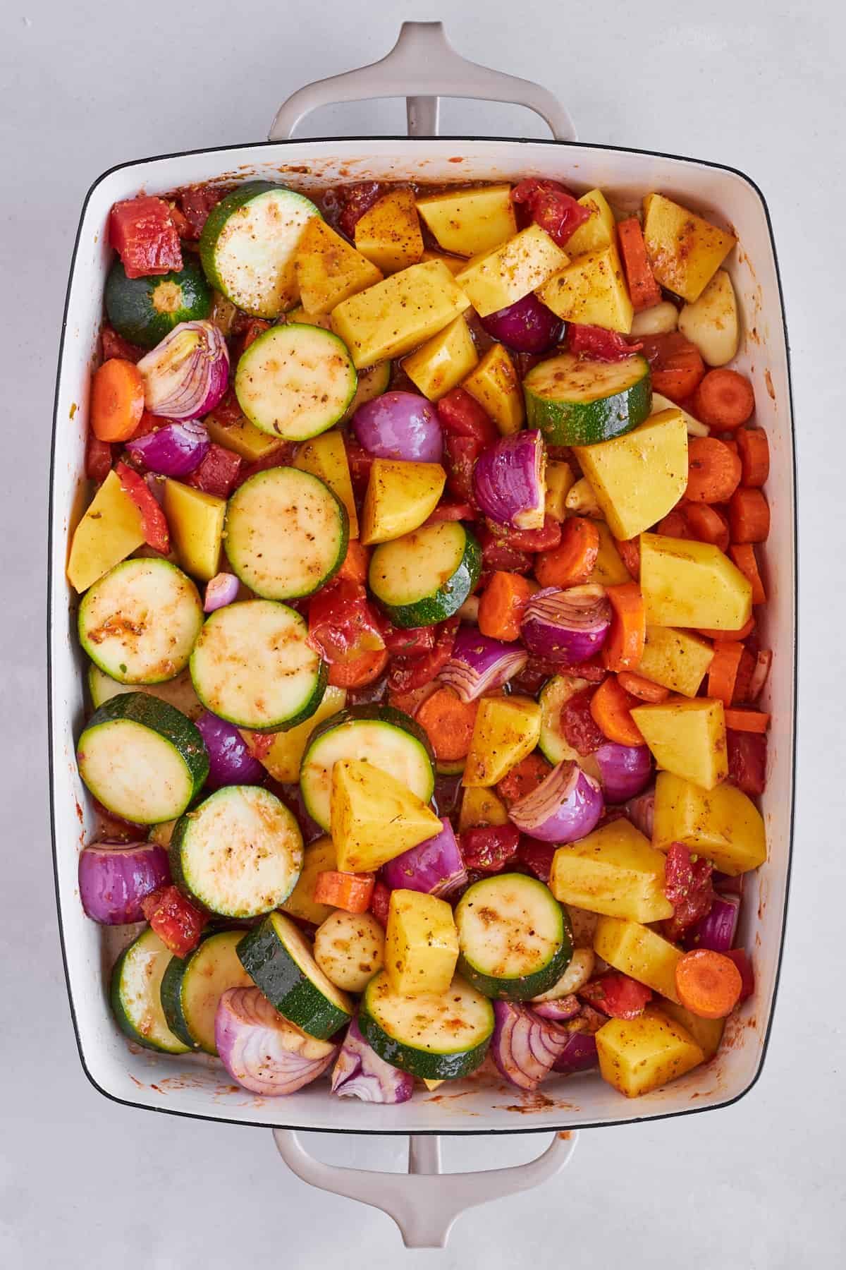 Seasoned veggies in a baking dish.