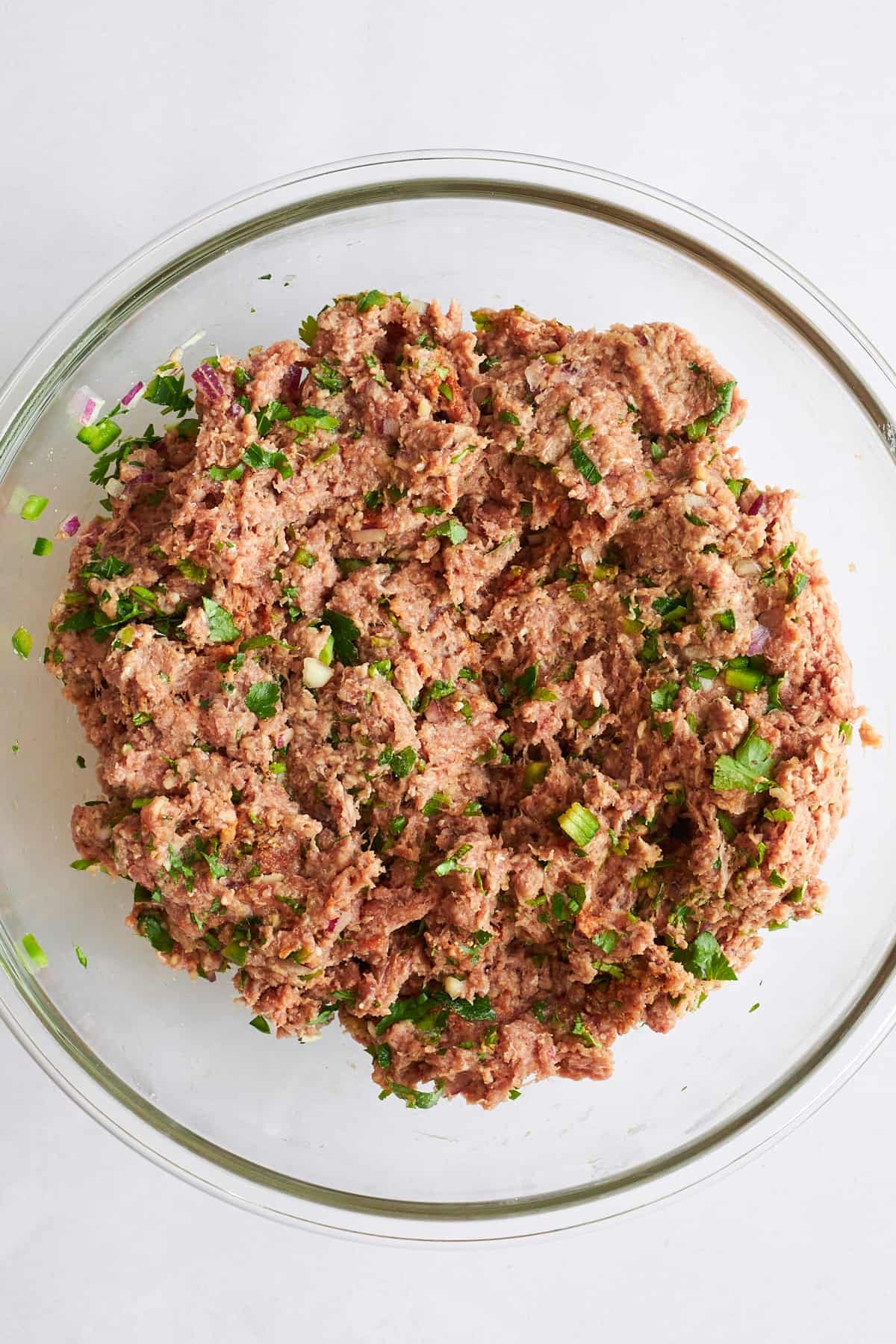 Raw beef kofta meatball mixture in a bowl.