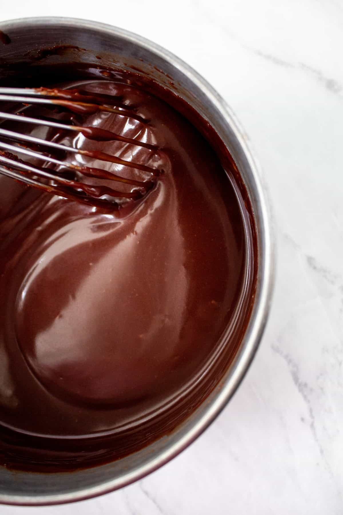 chocolate fudge topping being whisked