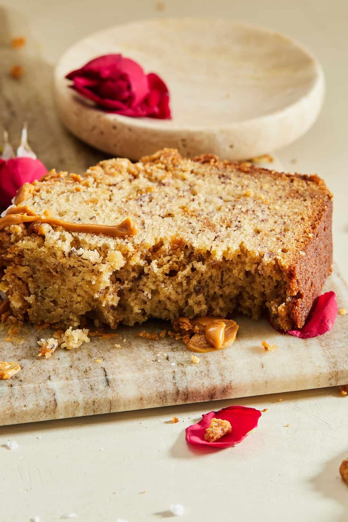 A slice of Biscoff banana bread with a bite taken out.