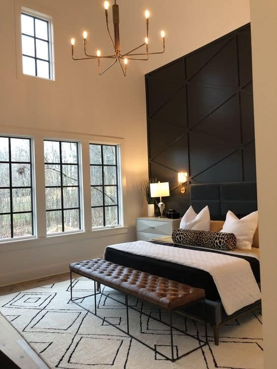 A wood plank black accent wall in a bedroom.