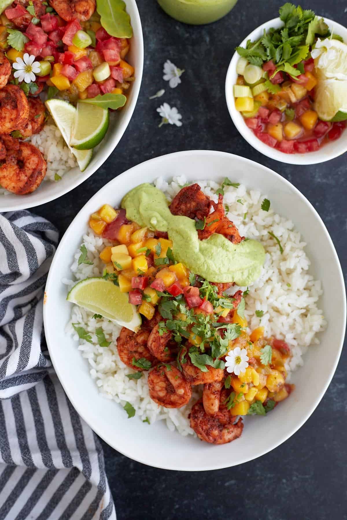 Blackened shrimp bowl topped with mango salsa and cilantro lime dressing.