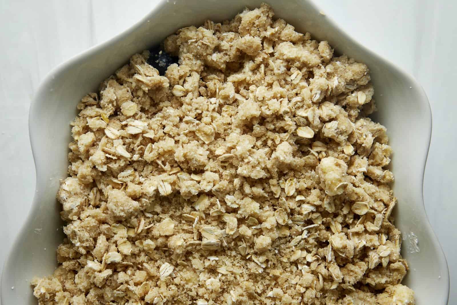 An unbaked blueberry crisp with a sweet oat topping.