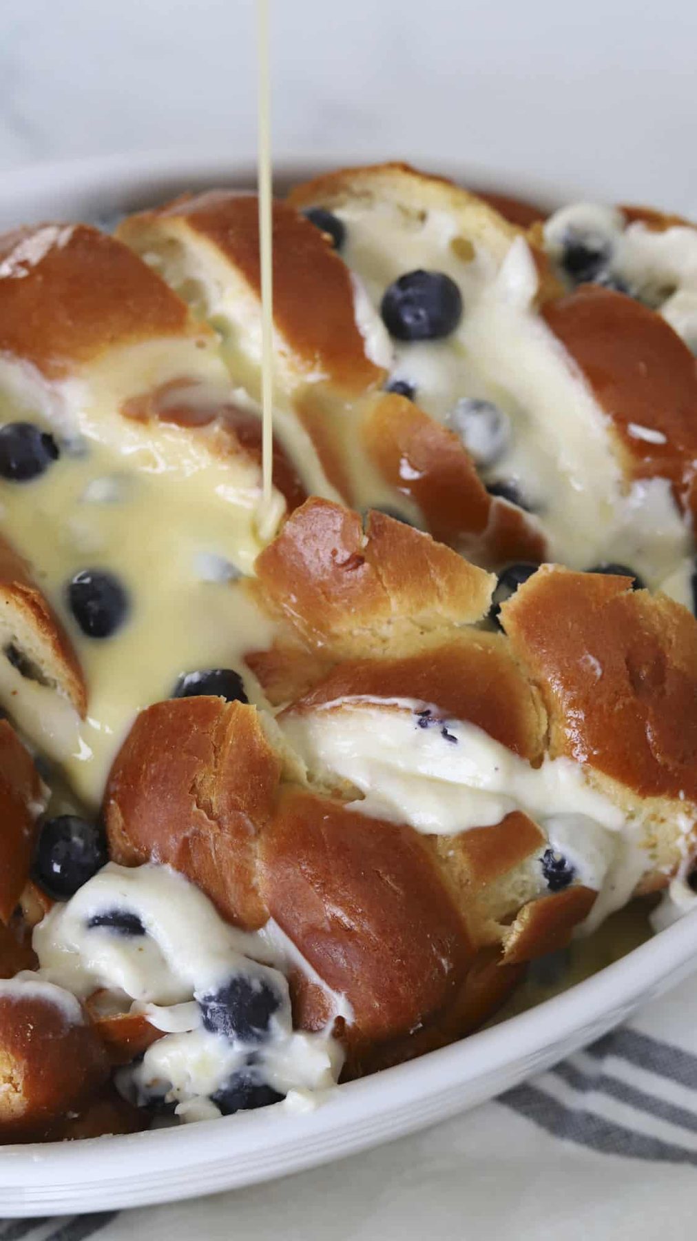 Pouring custard over the top.