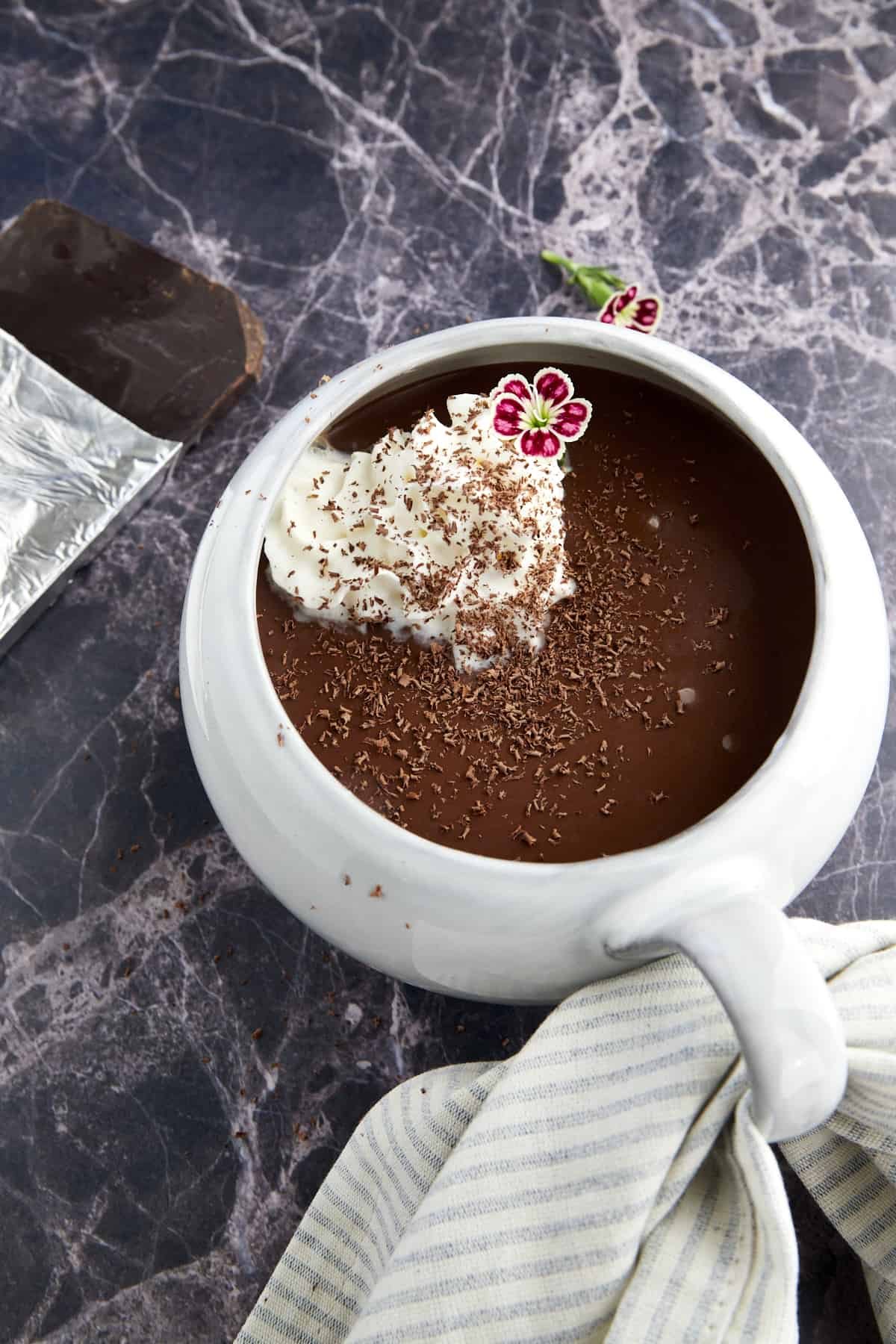 A mug of bone broth hot chocolate topped with whipped cream.