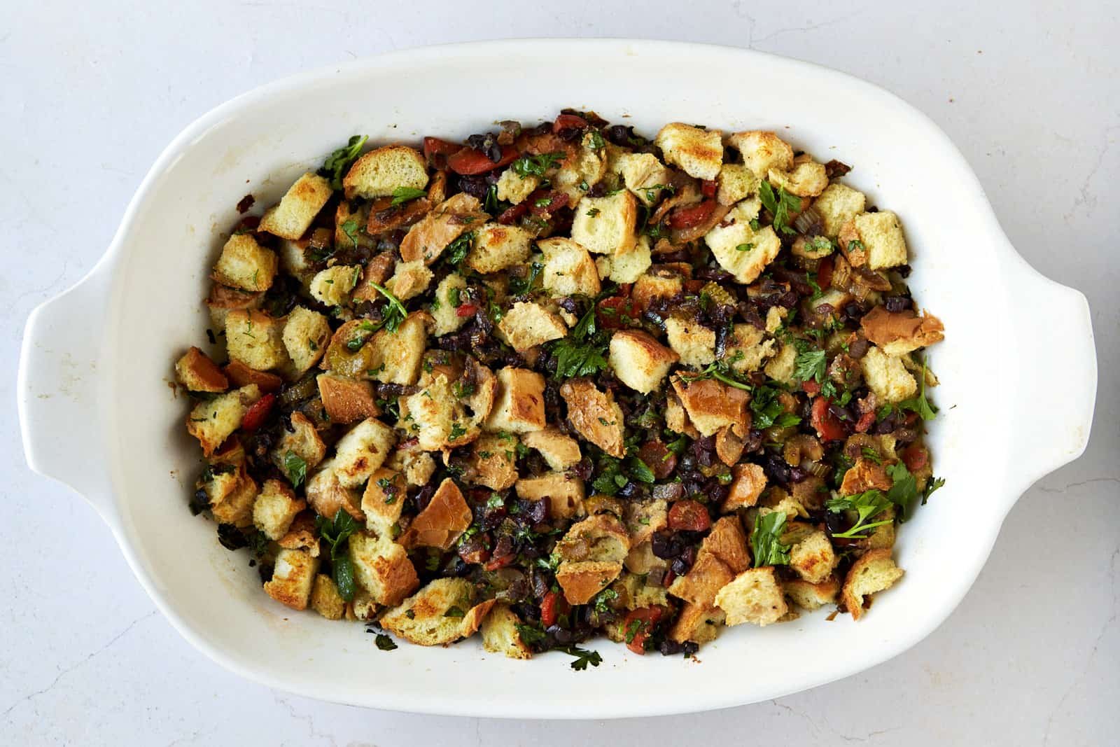 Mediterranean style bread dressing in a baking dish.