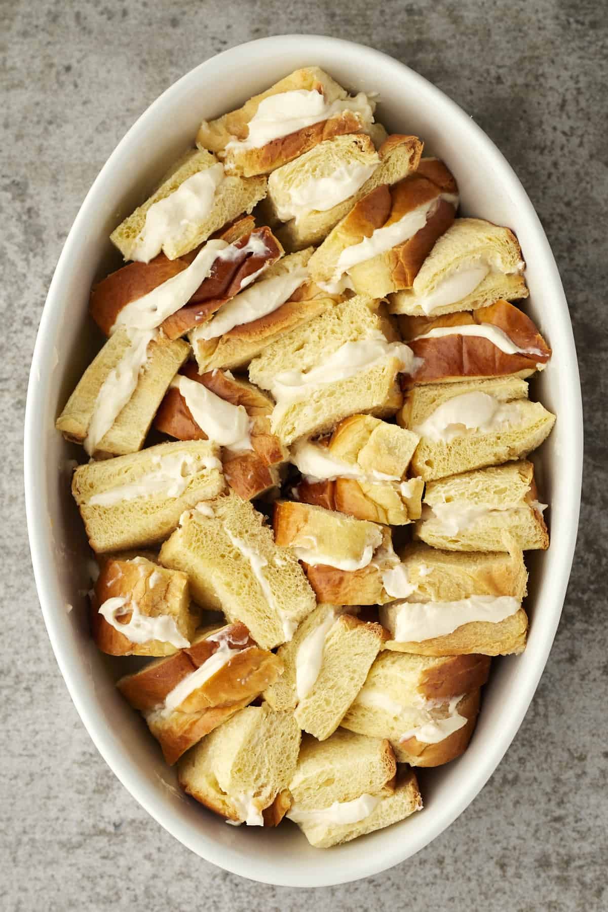 cannoli stuffed french toast pieces in an oval dish.