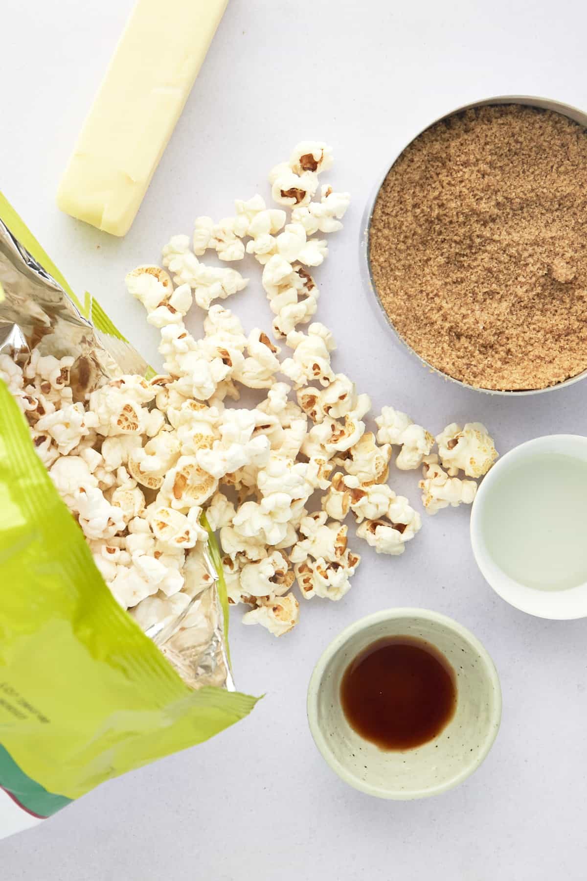 Popcorn, a stick of butter, brown sugar, corn syrup, and vanilla extract.