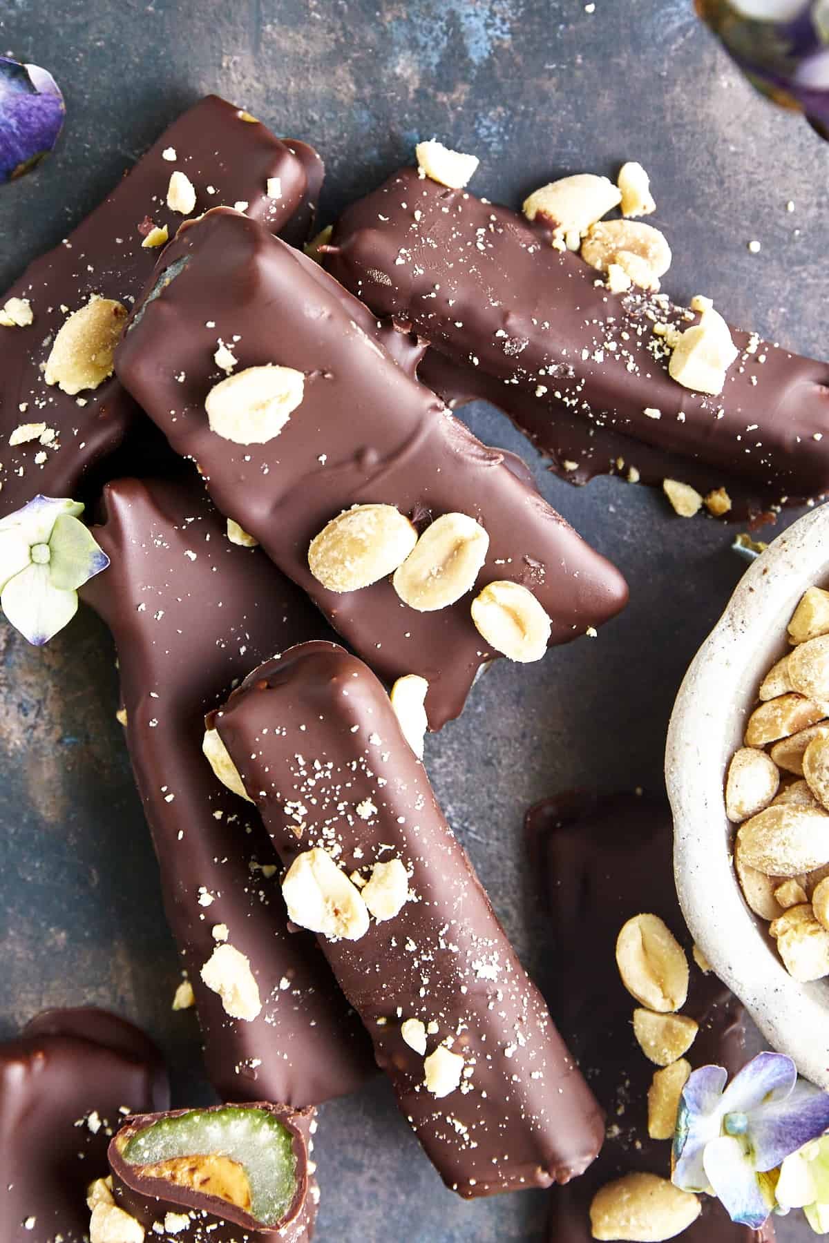 Overhead image of chocolate dipped celery with peanut butter logs topped with peanuts and sea salt.