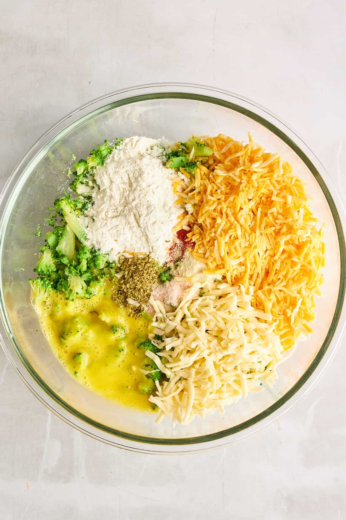 Ingredients for broccoli fritters in a bowl.