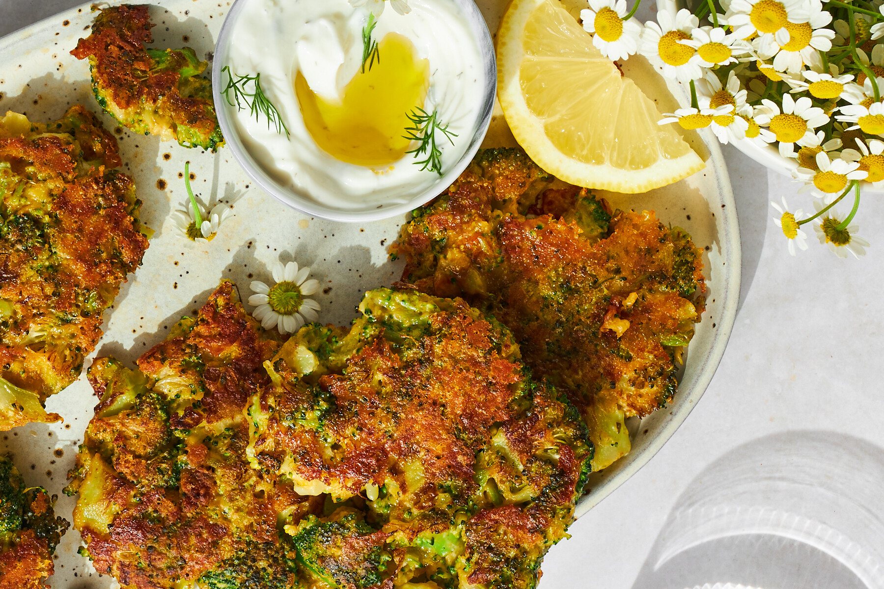 A plate of cheesy broccoli fritters.
