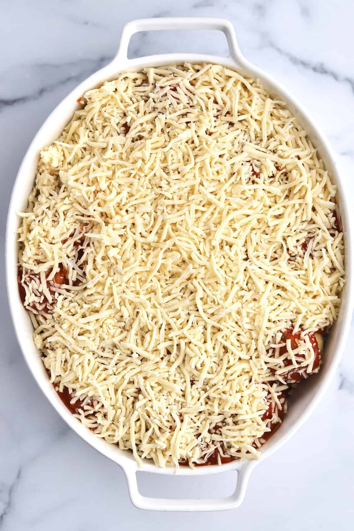 garlic knots topped with marinara and shredded cheese