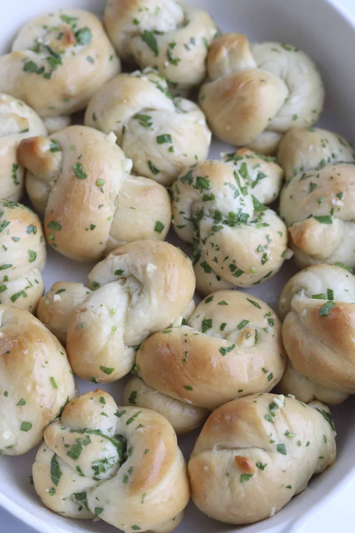 garlic knots topped with fresh herbs