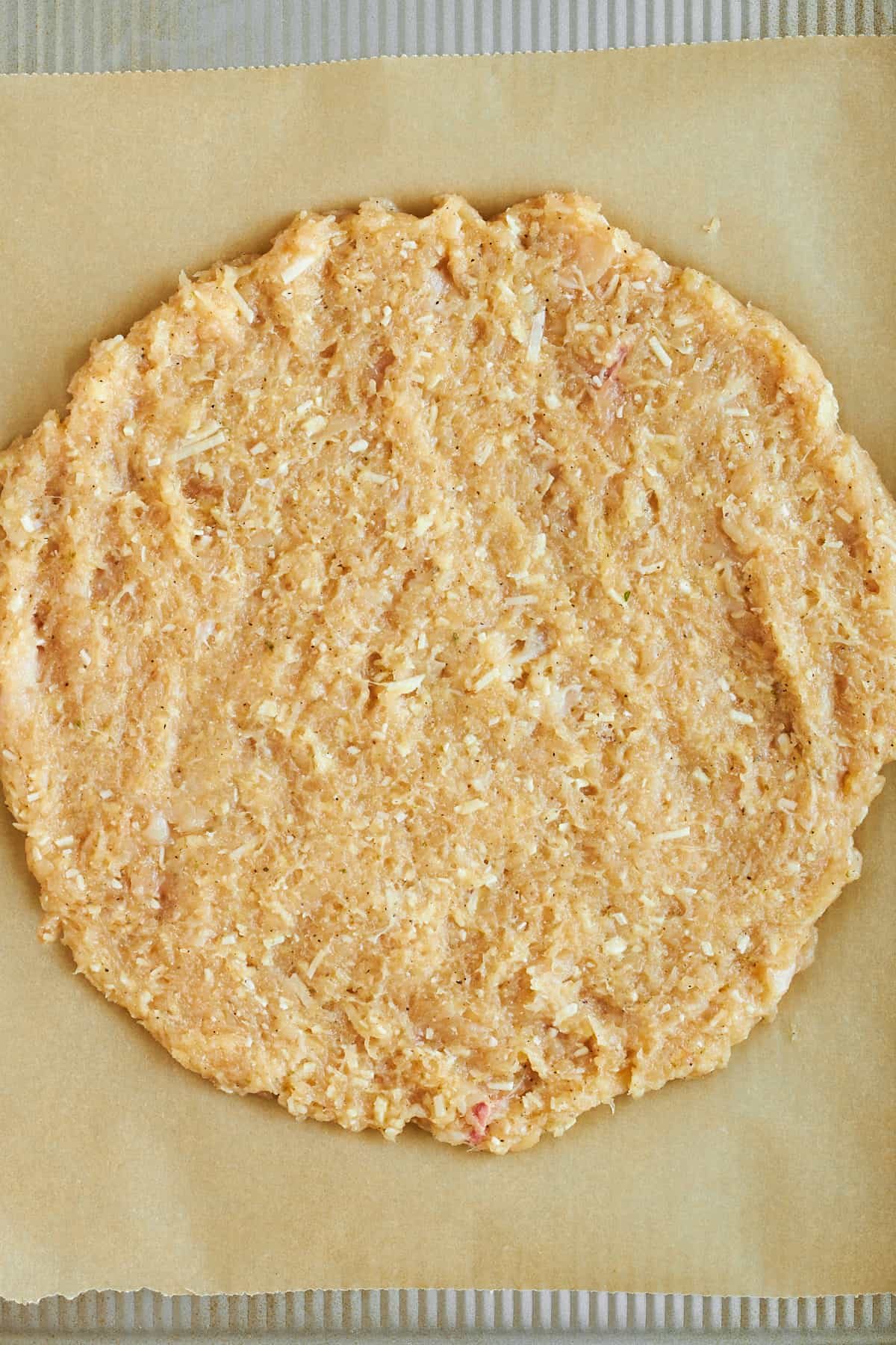 Raw chicken crust on a baking sheet.