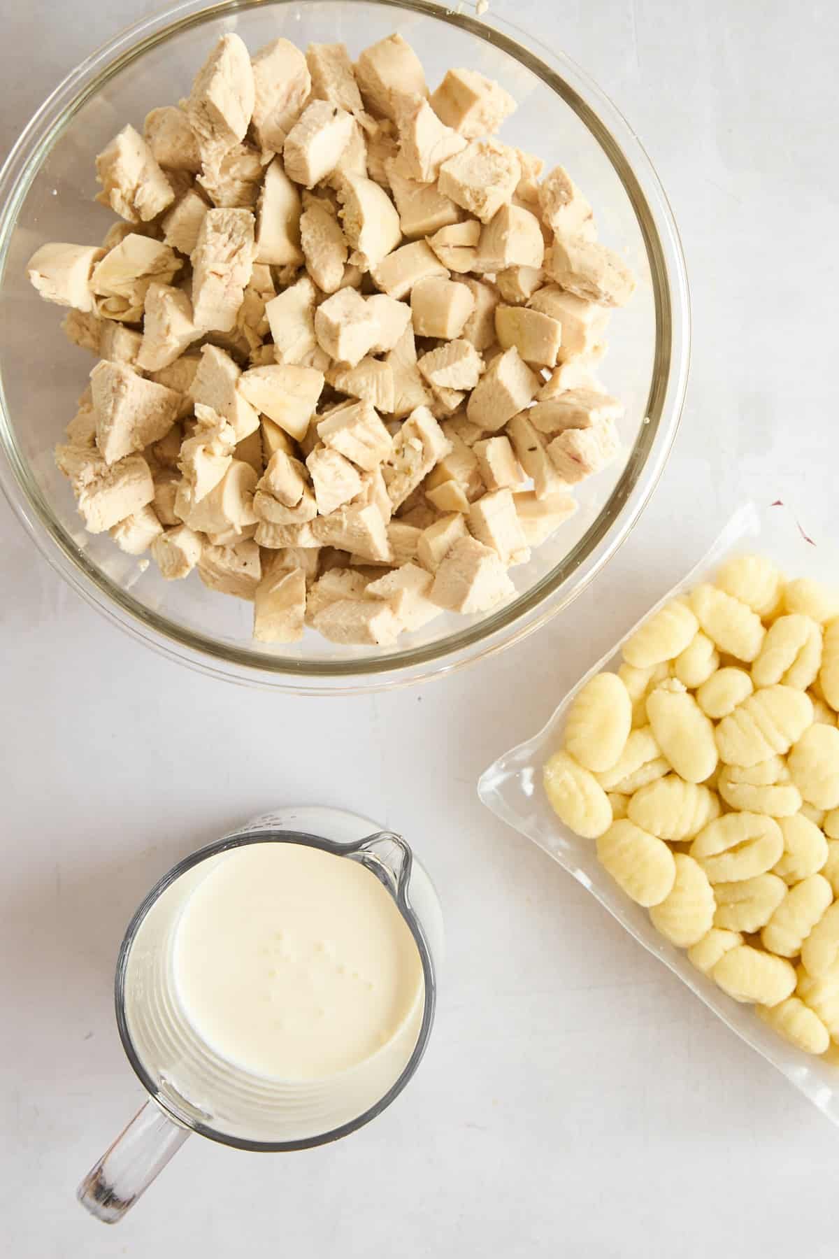 Chicken pieces, gnocchi, and cream.