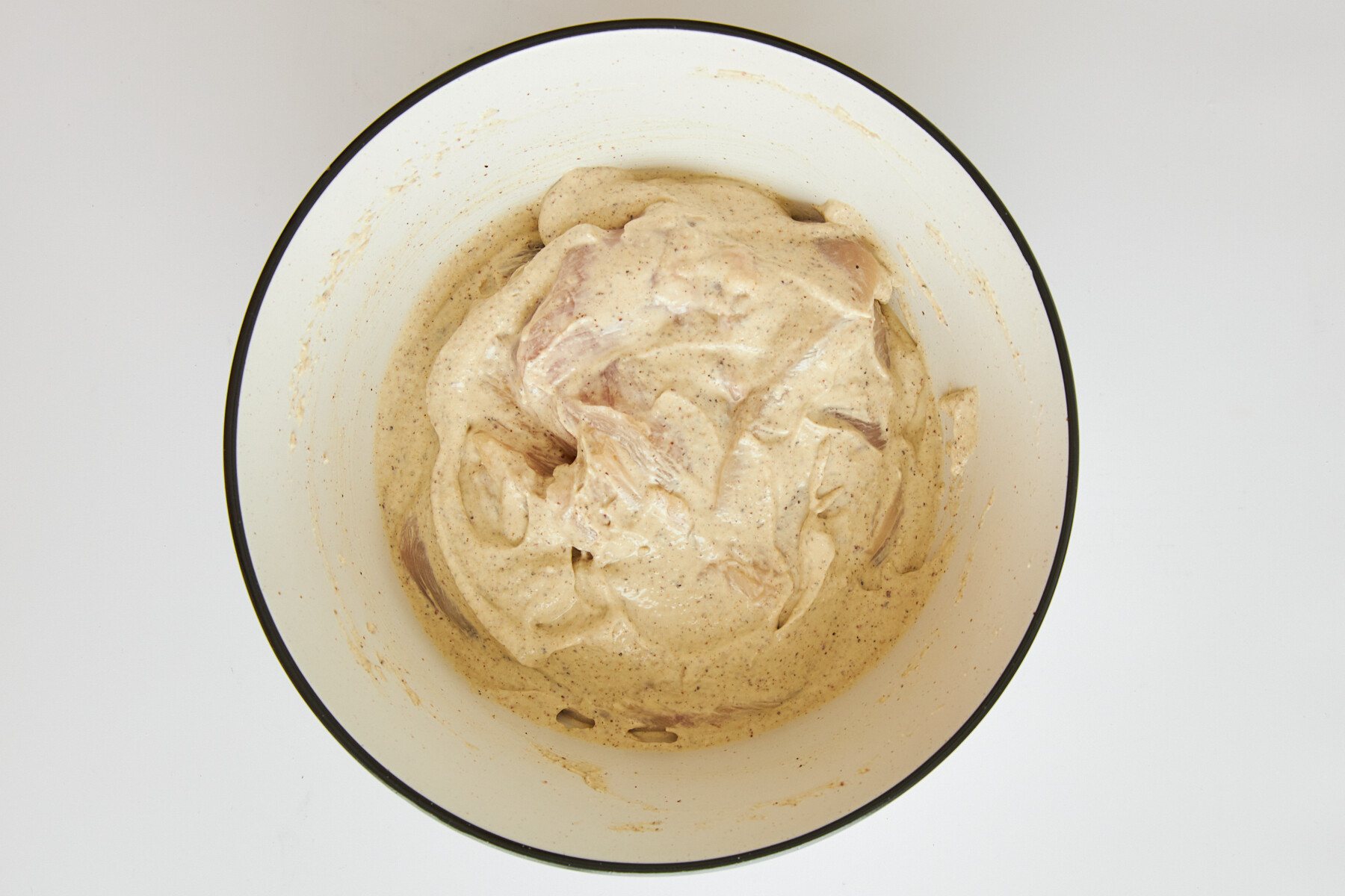 Raw chicken in tahini yogurt marinade.