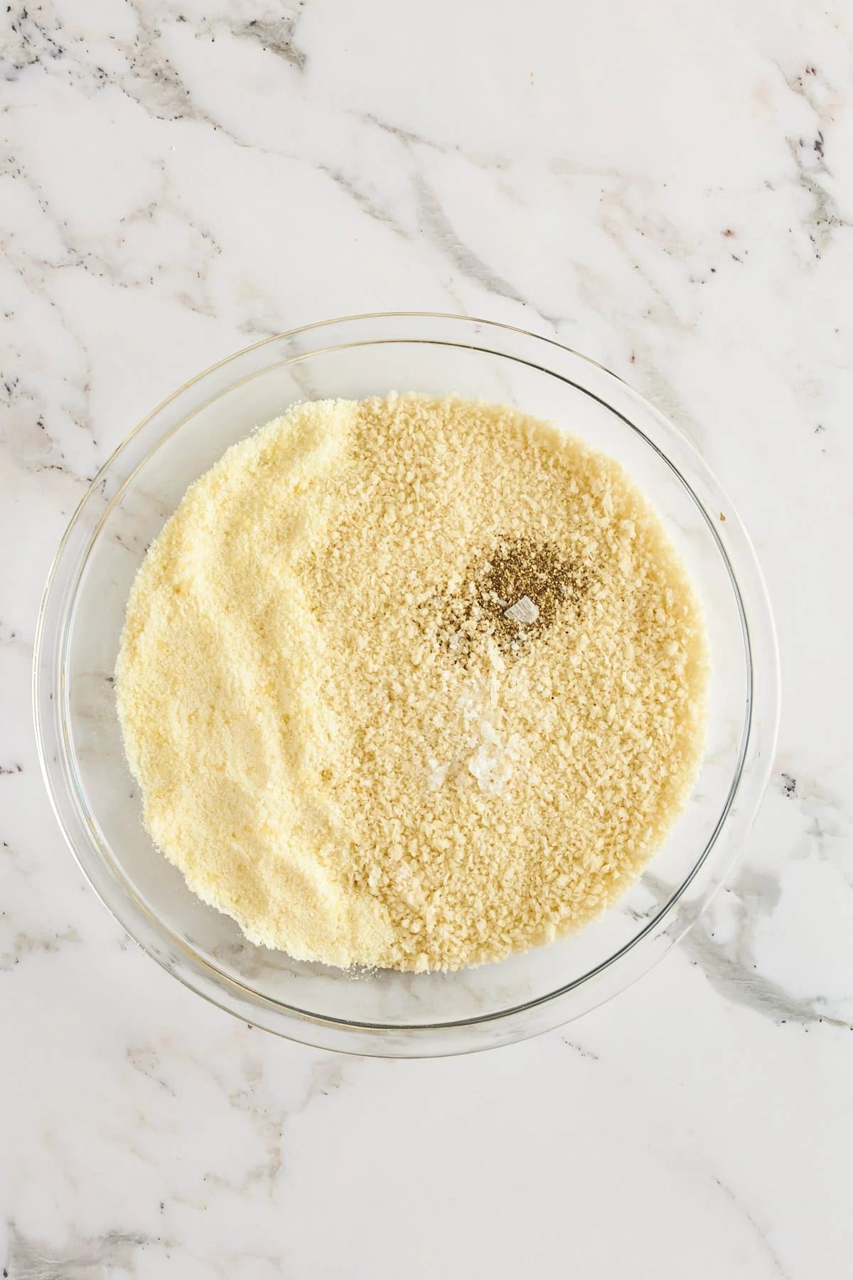 Breadcrumbs and cheese in a bowl.