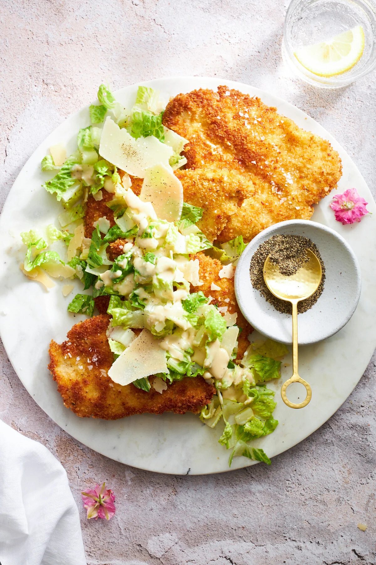Chicken Milanese Recipe with Caesar Salad at the Table