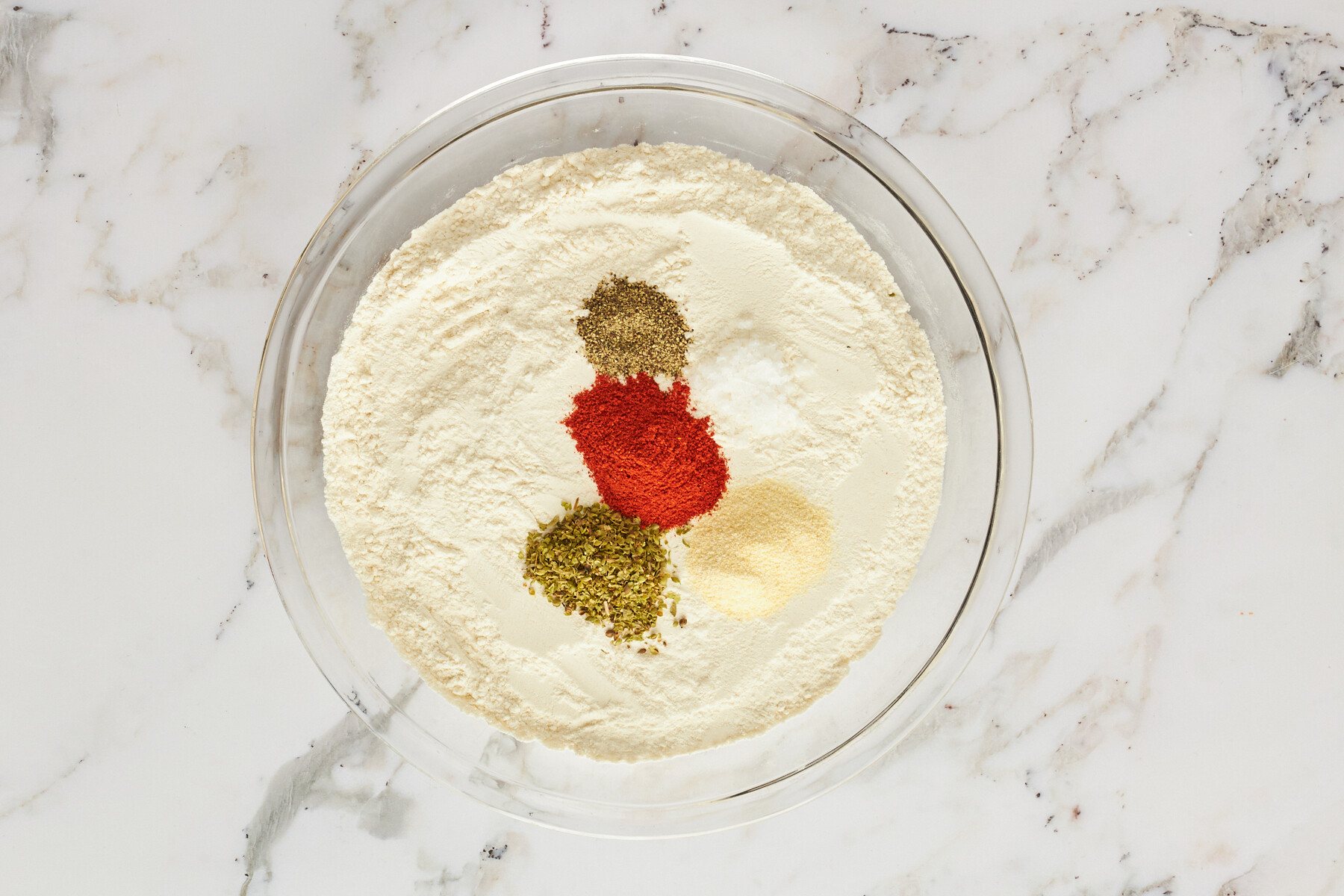 A bowl of flour and seasonings.