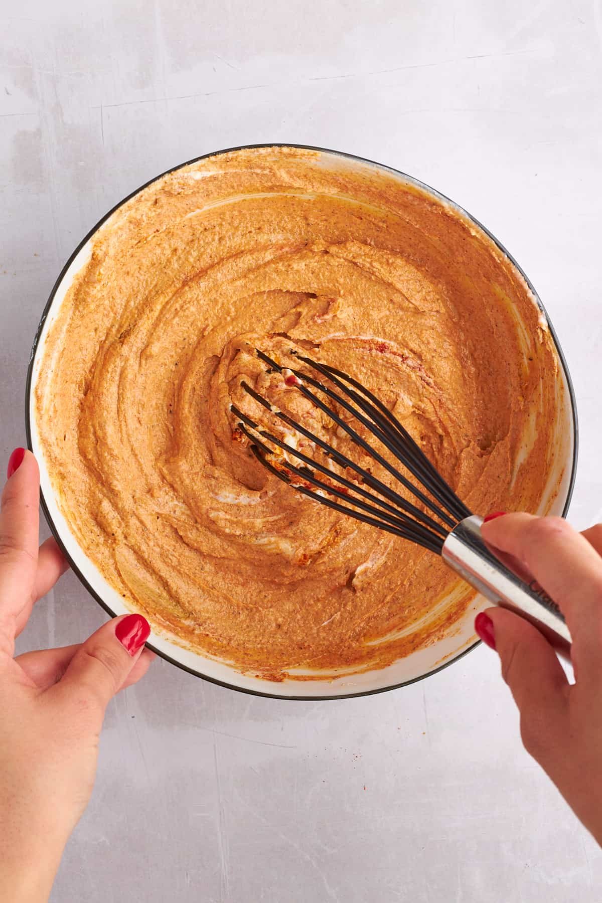 Shawarma marinade being whisked in a bowl.