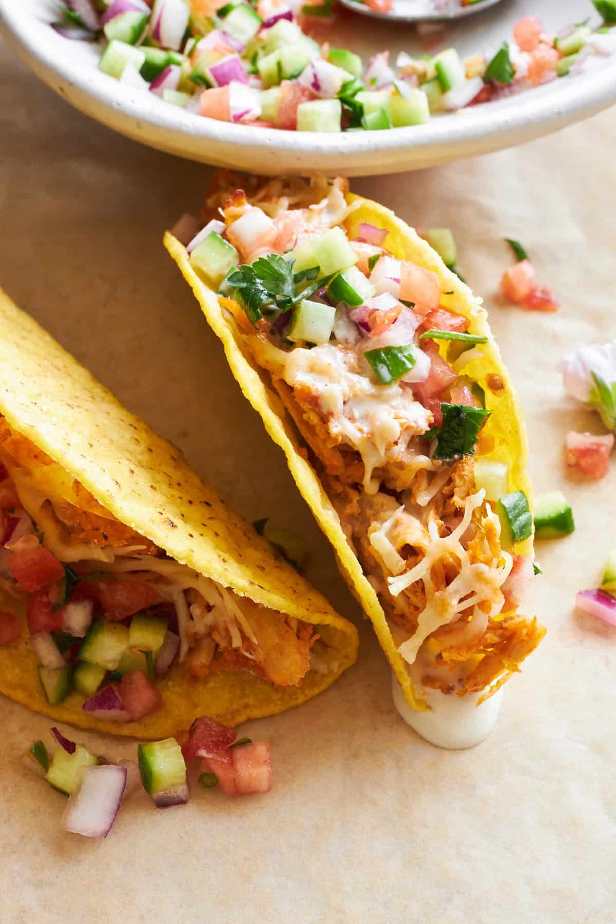 Chicken shawarma taco topped with shirazi salad.