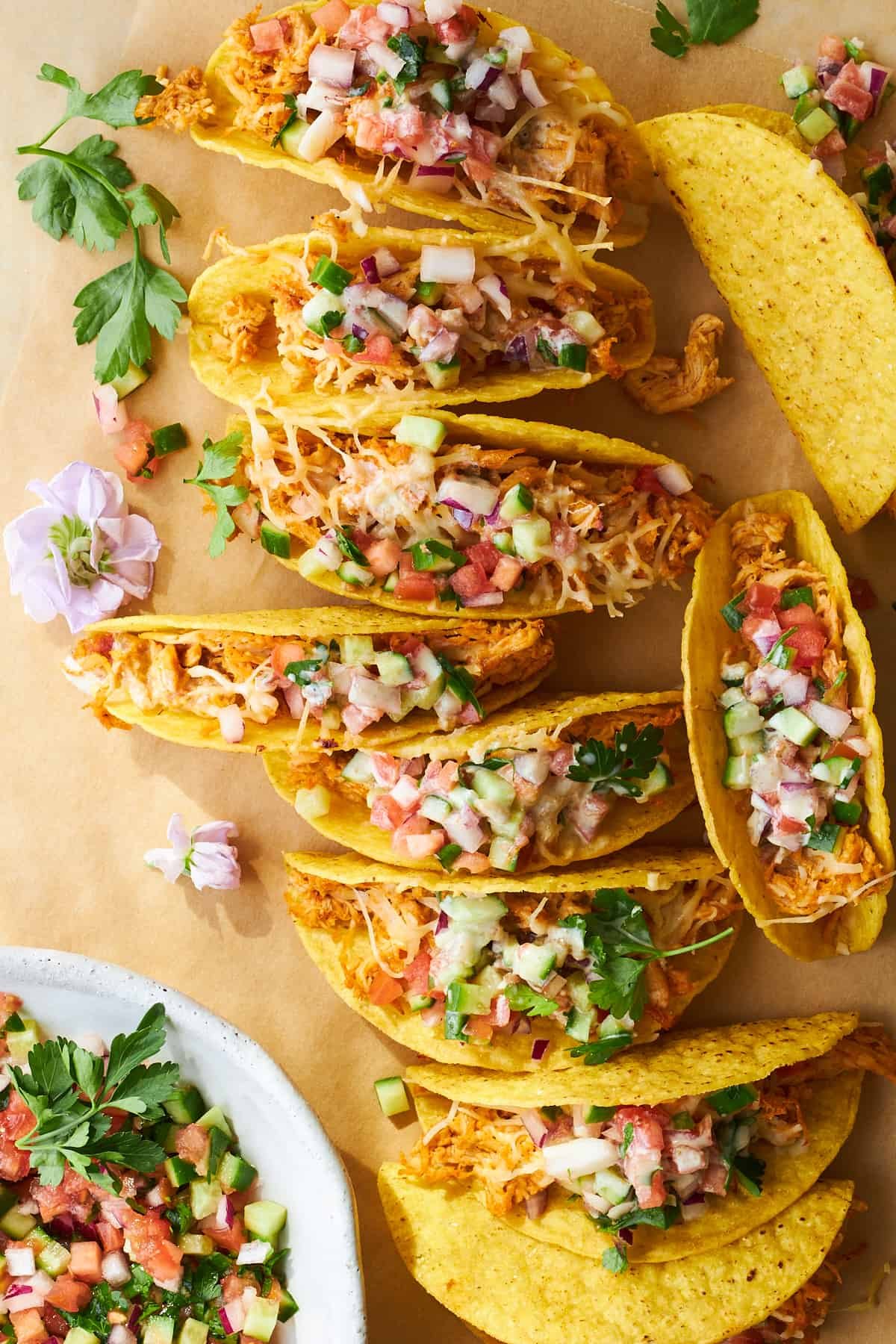 Baked chicken shawarma tacos with shirazi salad and tahini sauce.