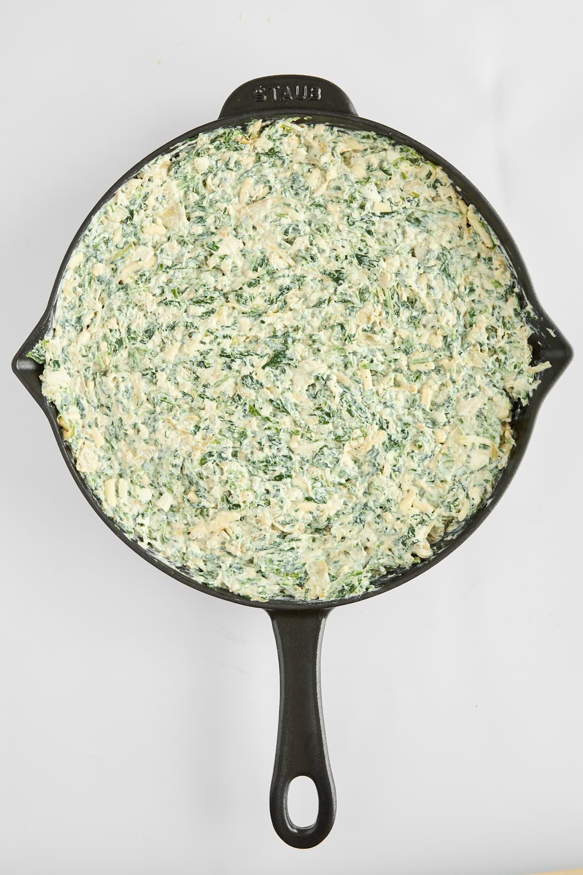 Unbaked chicken spinach and artichoke dip.