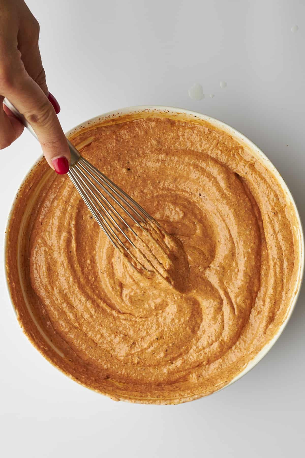 Chicken tikka marinade being whisked.