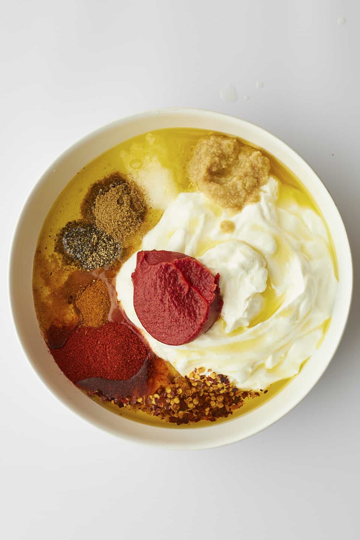 Ingredients for chicken tikka marinade in a bowl.