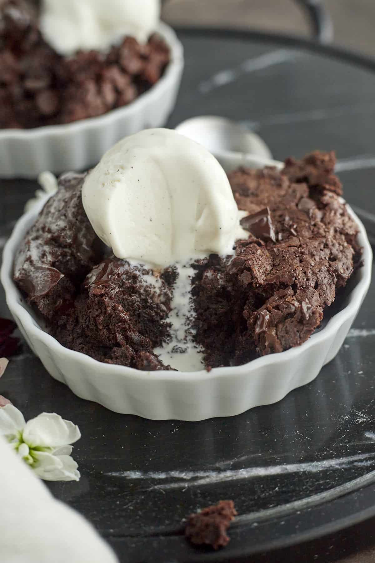 a serving of brownie topped with vanilla ice cream