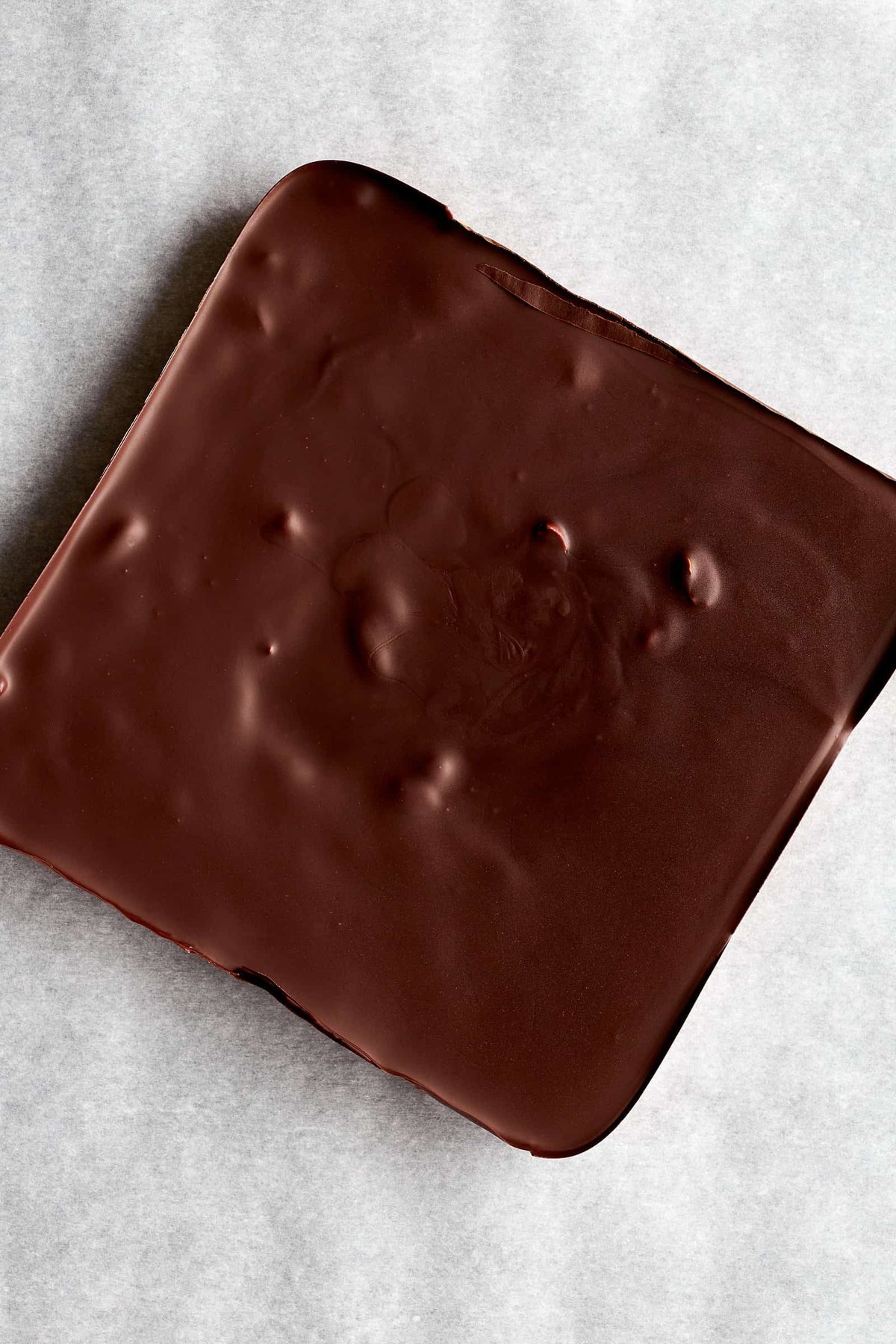 A slab of chocolate peanut butter bars ready to be sliced.