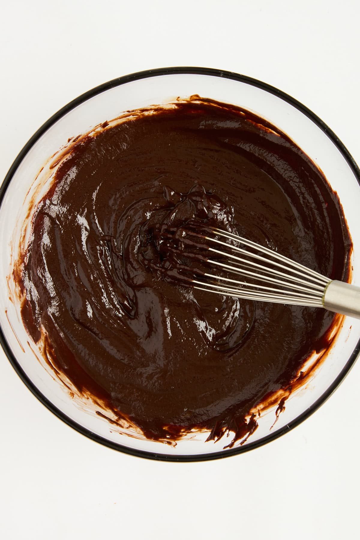 Chocolate souffle batter being whisked.