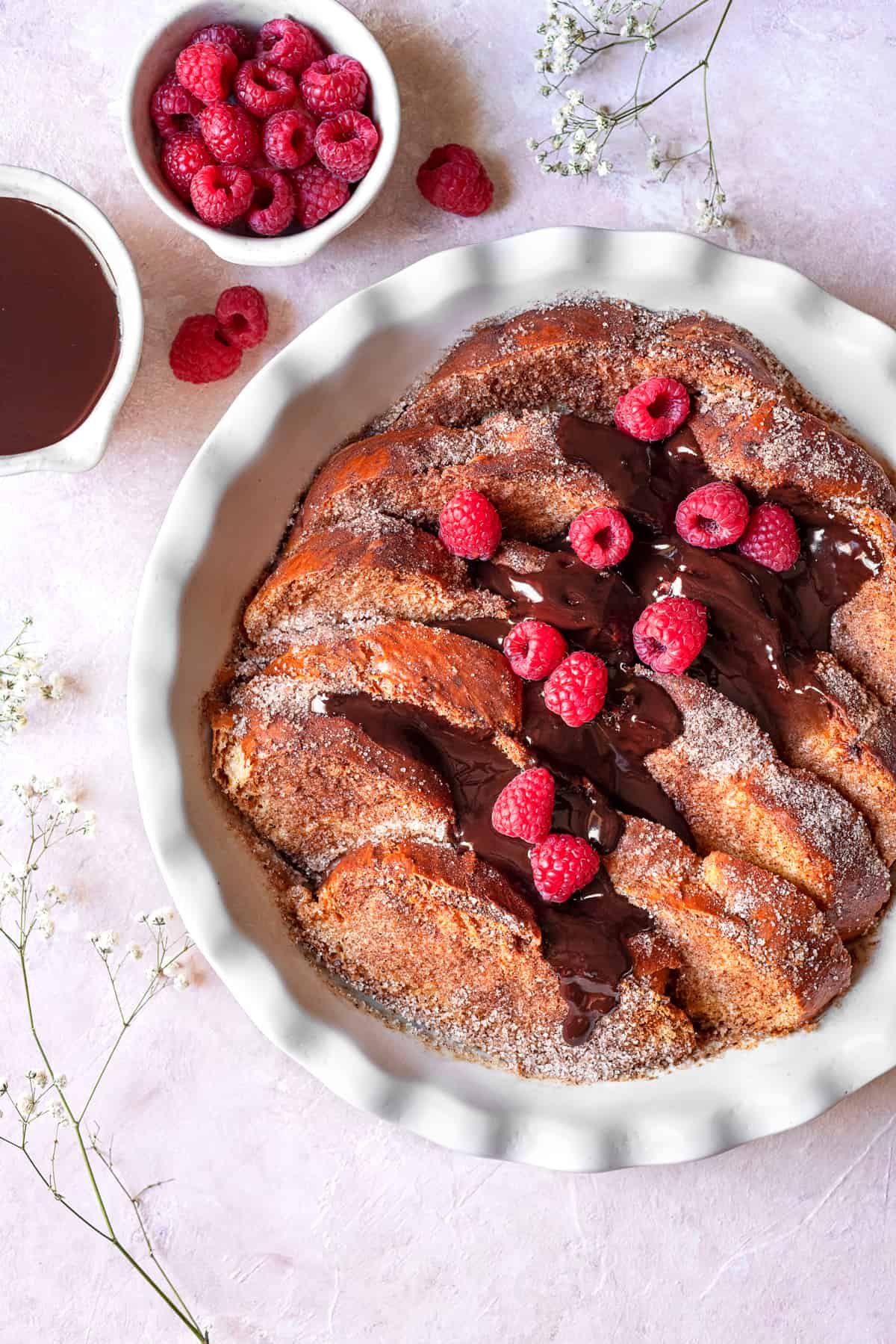 overhead churro french toast with chocolate and raspberries